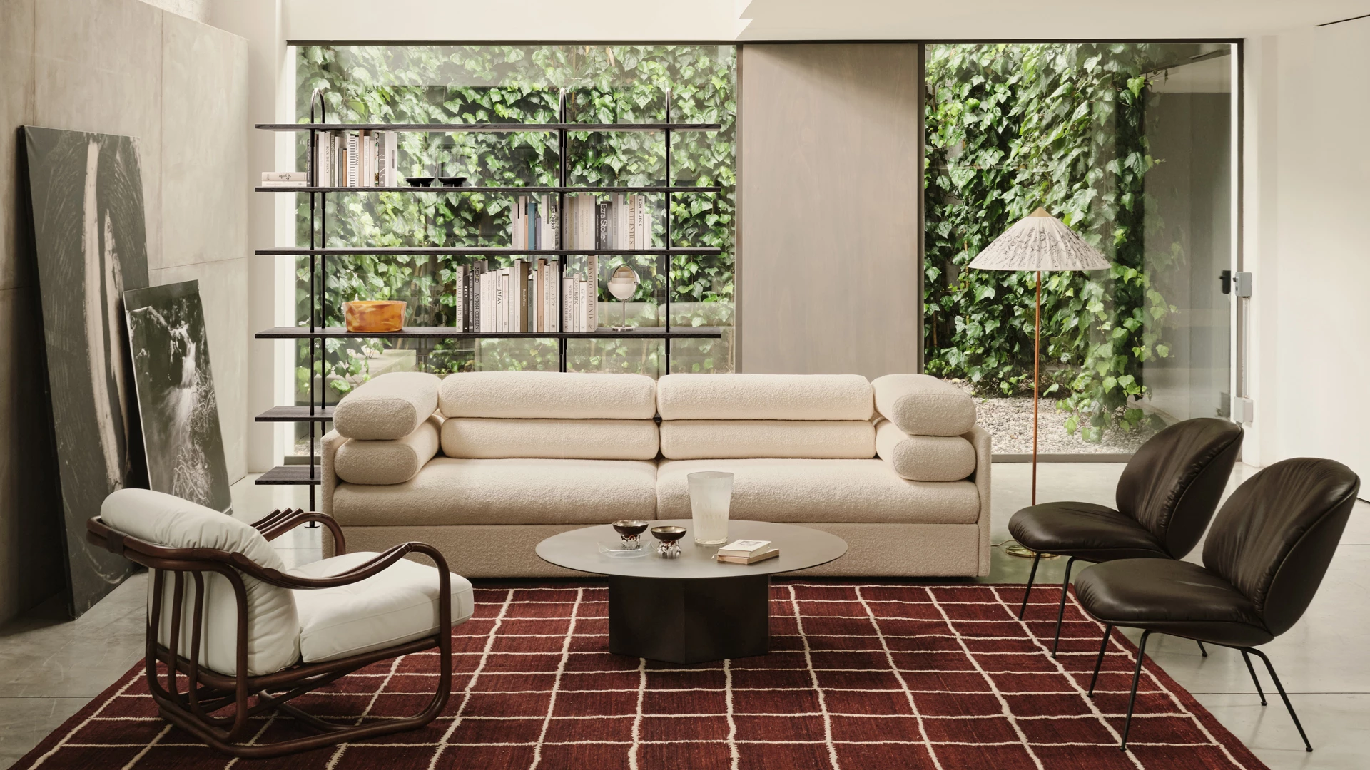 GUBI Elogio sofa in a sunlit living room with lounge chairs and a garden outlook
